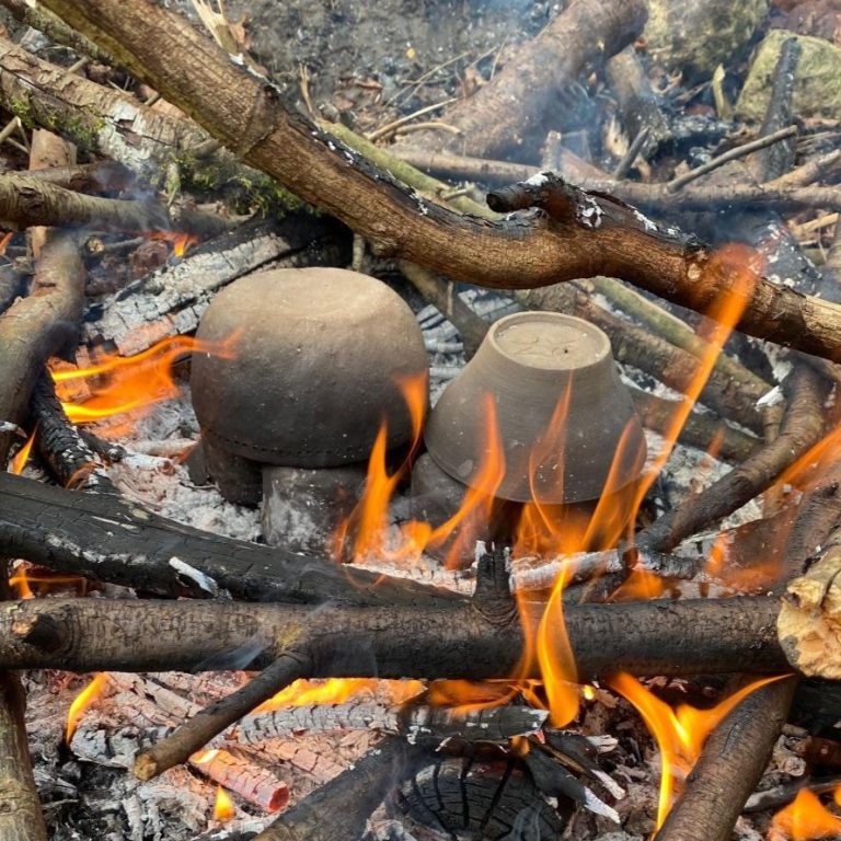 poterie ancestrale en cours de cuisson au feu de bois
